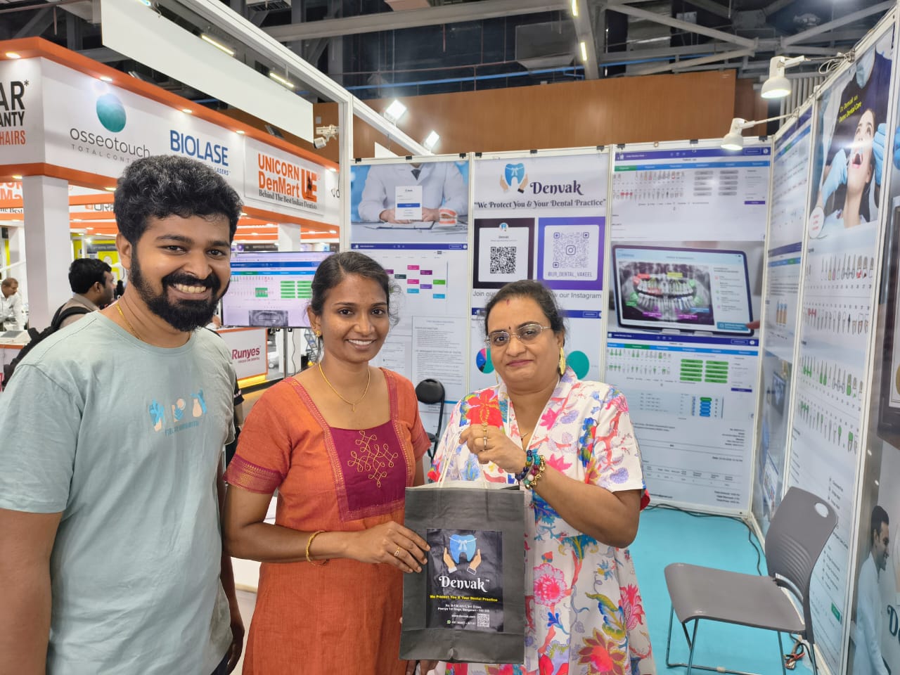 Denvak team handing a kit to dental delegates at Expodent Chennai 2026